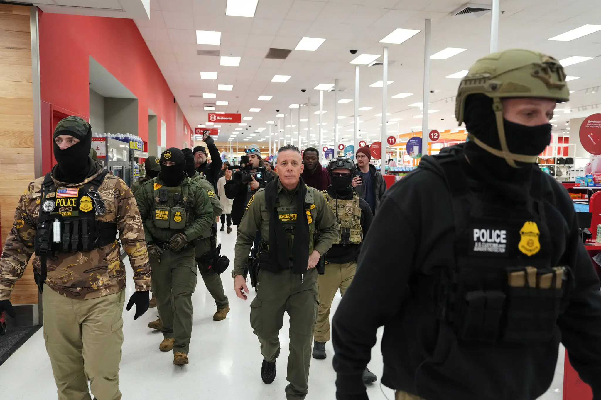 Gregory Bovino, center, a Border Patrol official, at a Target store in St. Paul, Minn., this month. Last week, agents detained two employees at a Target in Richfield, Minn.