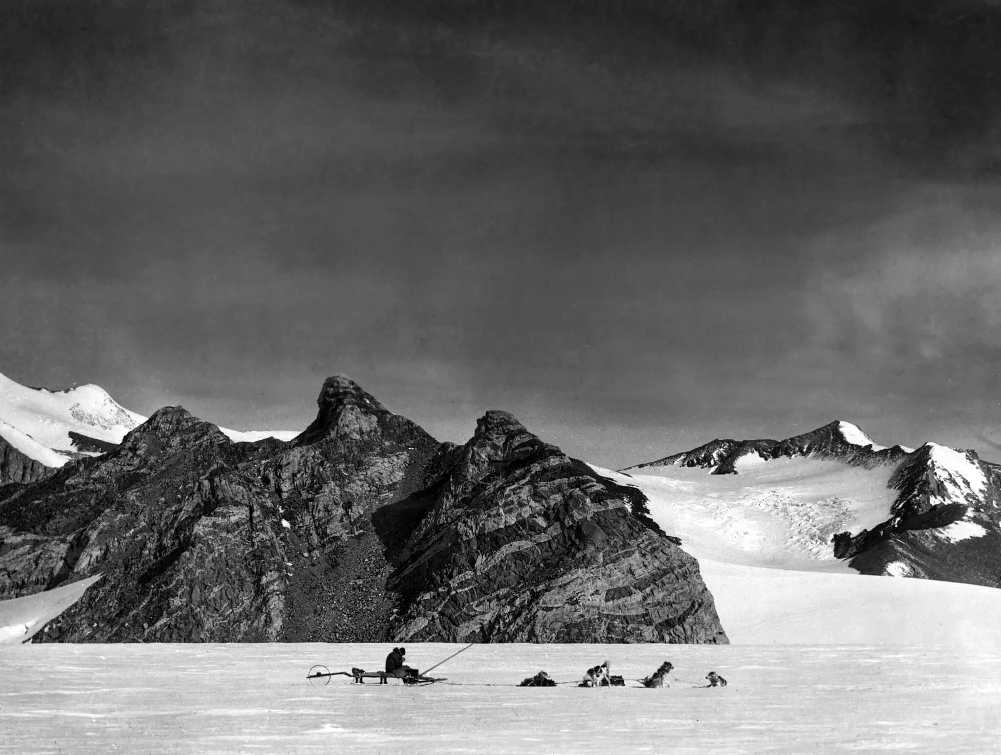 One of the dog teams of the Byrd Expedition resting in the foothills near the Axel Heiberg Glacier on the Ross Ice Shelf in Antarctica in 1930.