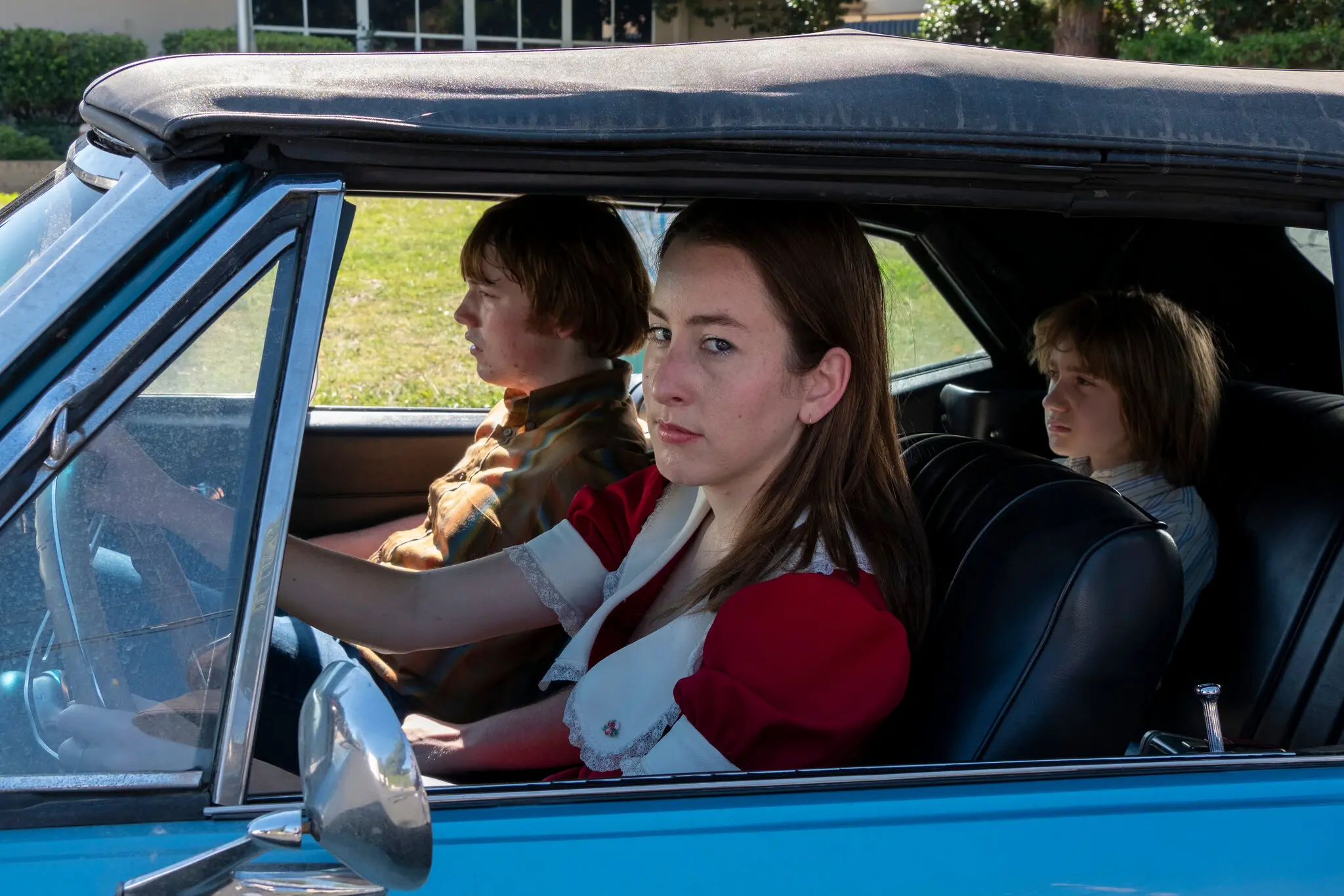 Cooper Hoffman, left, and Alana Haim, center, in the Paul Thomas Anderson film “Licorice Pizza.”