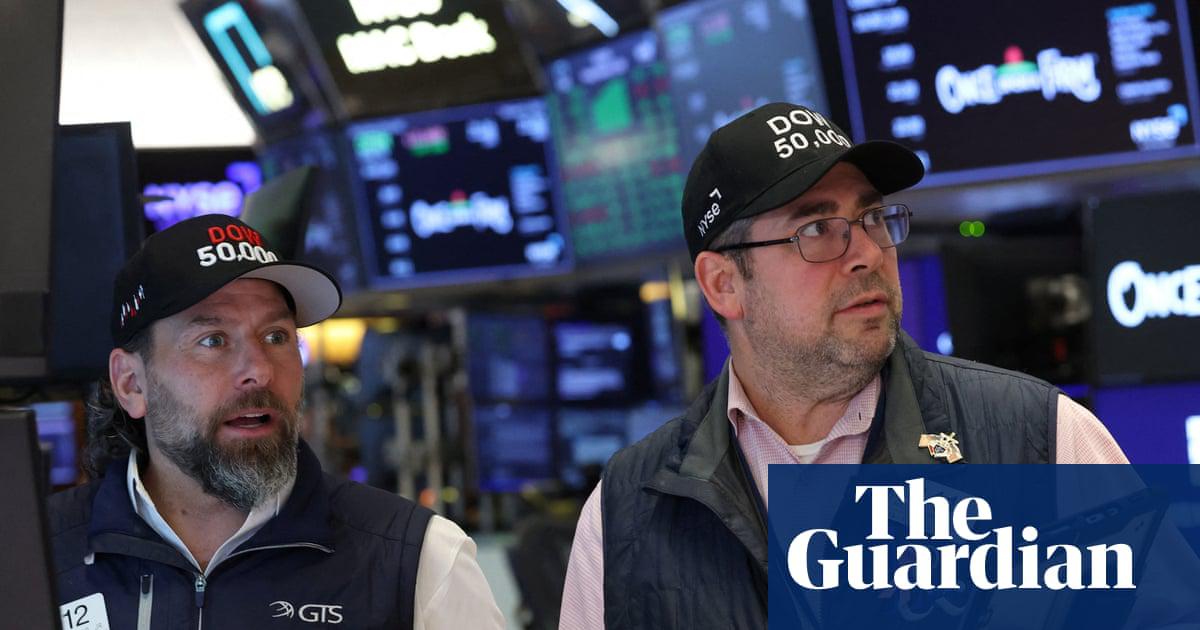 Traders react as the Dow Jones Industrial Average surpasses the 50,000 mark, at the New York Stock Exchange in New York City, on Friday.