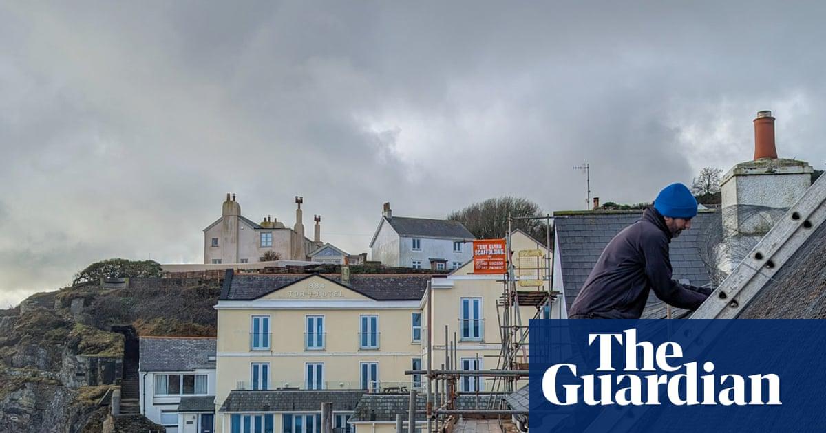 Repairing a thatched roof in Torcross, Devon, after the storms.