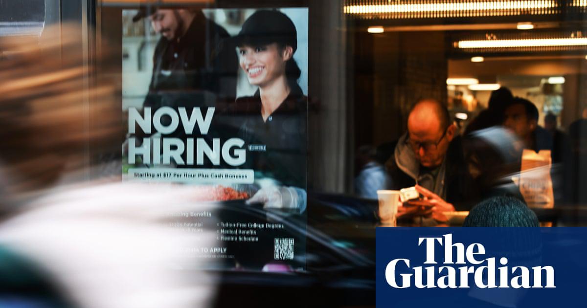 A hiring sign is displayed in the window of a business in New York City, on 27 November 2025.