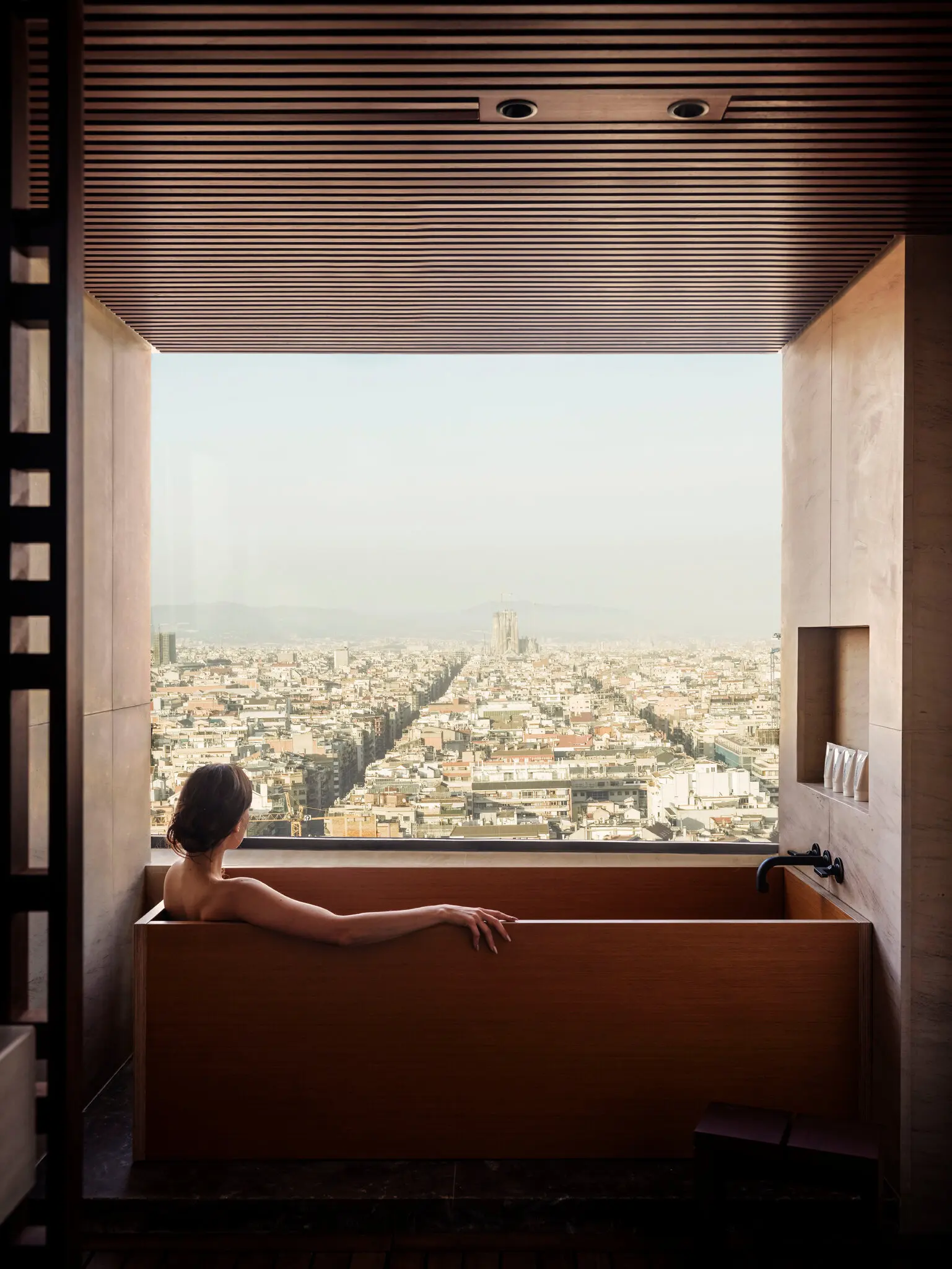 At the Nobu Barcelona hotel, guests fill in pre-stay questionnaires listing their requirements. Some rooms feature baths with views of the Sagrada Familia Basilica designed by Antoni Gaudí.