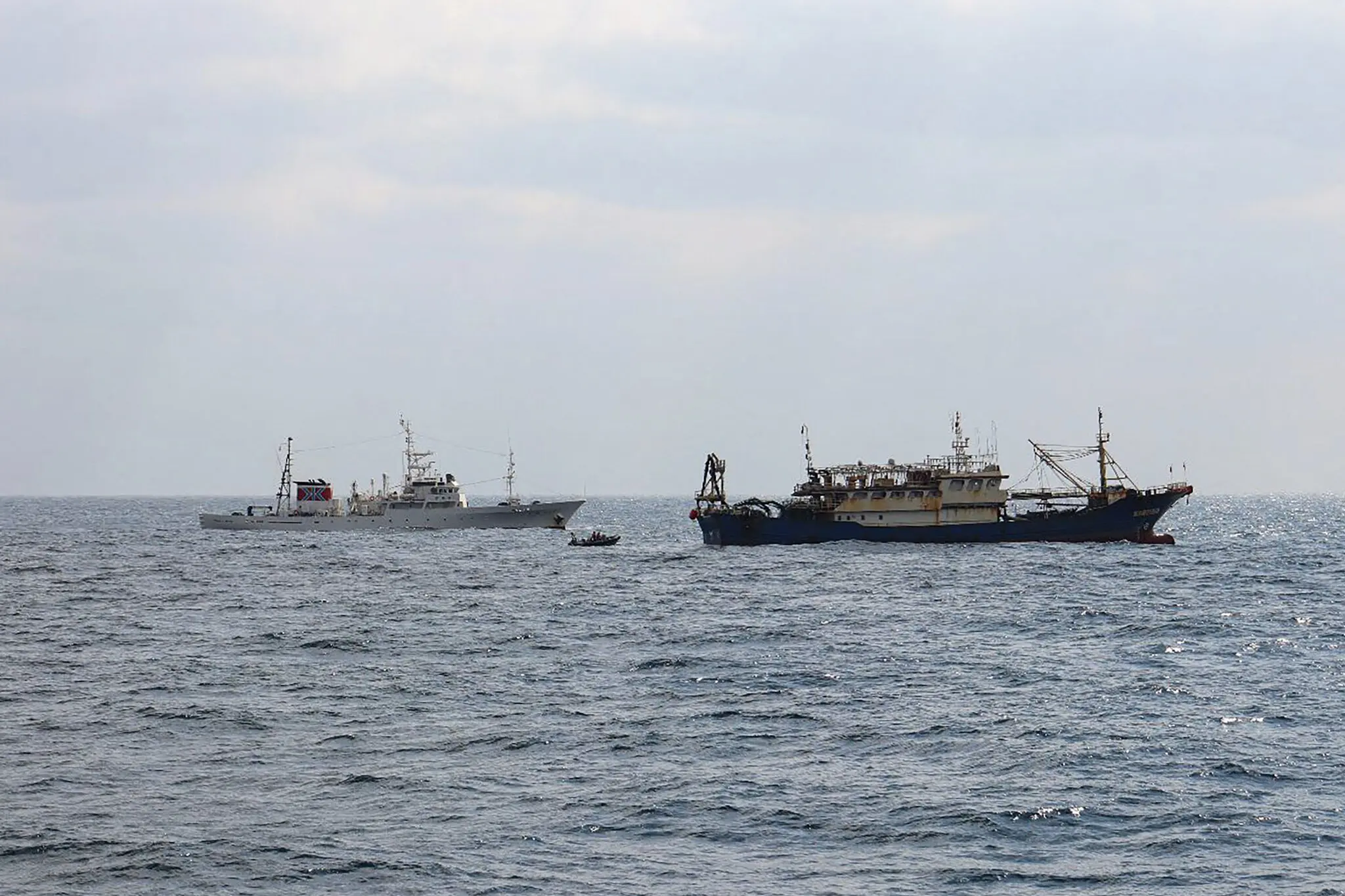 A photo released by Japan’s Fisheries Agency shows a Japanese patrol vessel, left, and a Chinese fishing boat that was seized off the coast of Nagasaki on Thursday.