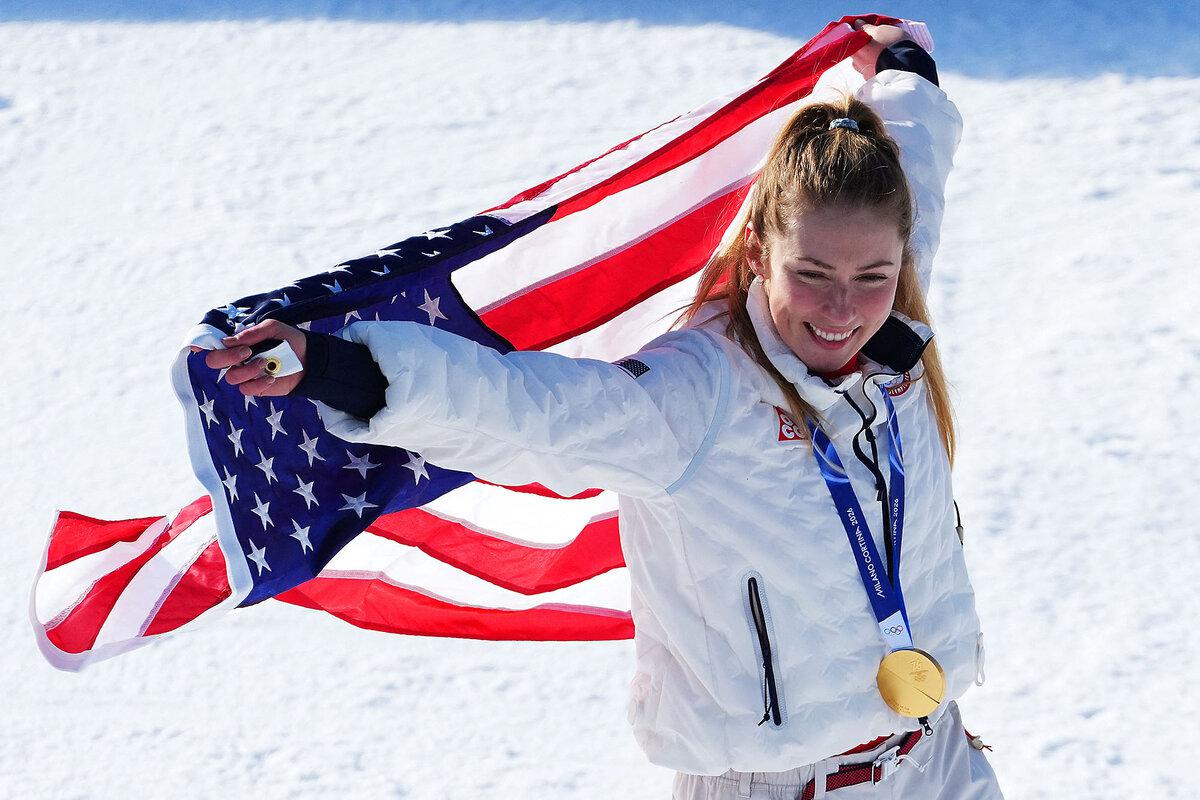 Gold medallist Mikaela Shiffrin of the United States celebrates with an American flag following the women’s slalom event in Cortina d’Ampezzo, Italy, Feb.18, 2026.