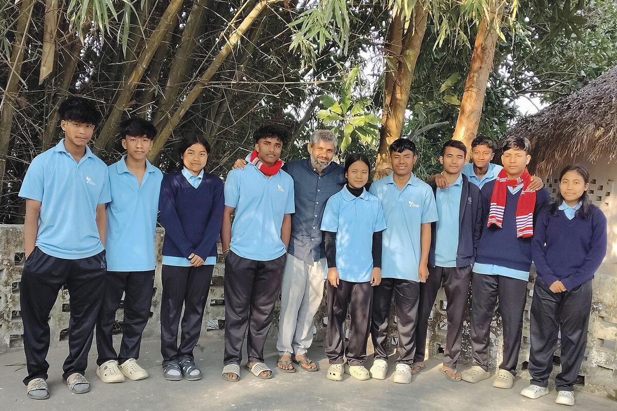 Bipin Dhane, founder of The Hummingbird School (center), stands with some of the older students.