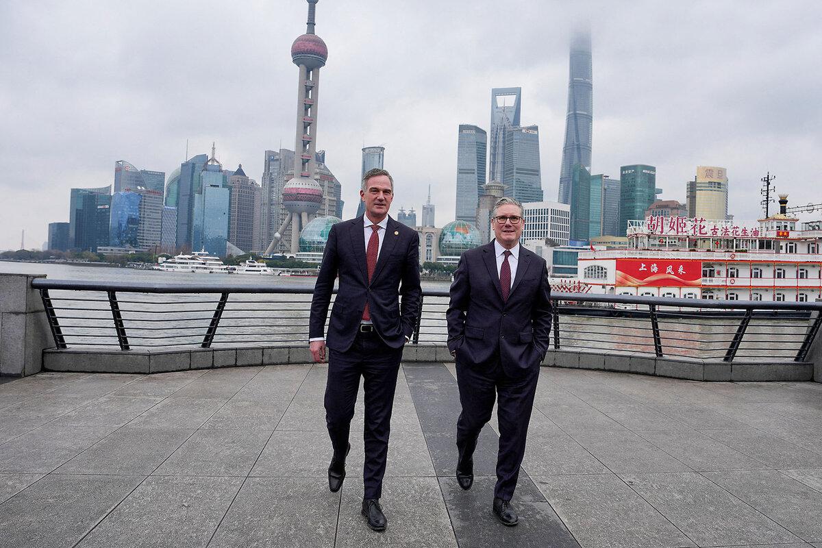 Britain's Prime Minister Keir Starmer and Secretary of State for Business and Trade Peter Kyle visit a waterfront promenade in Shanghai, Jan. 31, 2026.